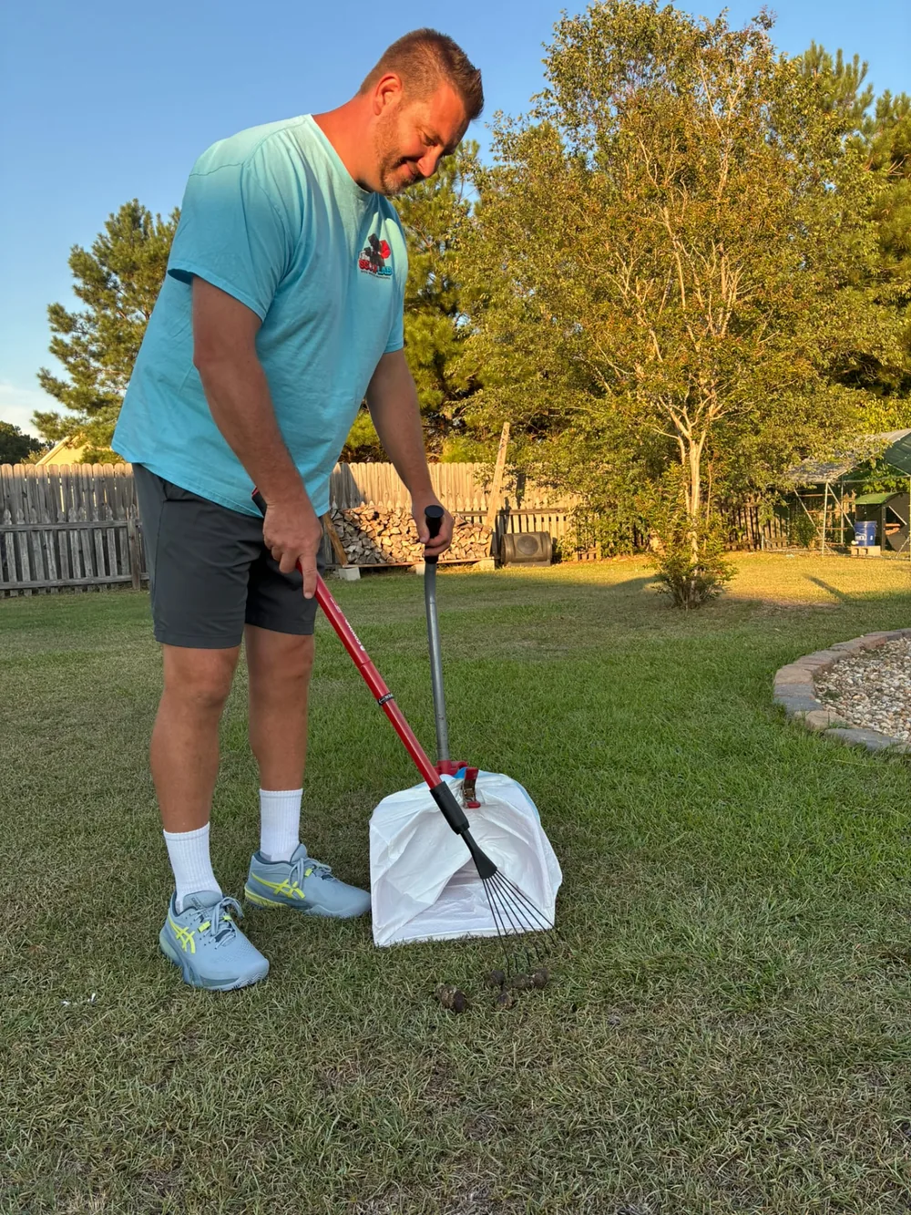 Scoop Lab team member performing dog waste removal in a Pitt County residential yard